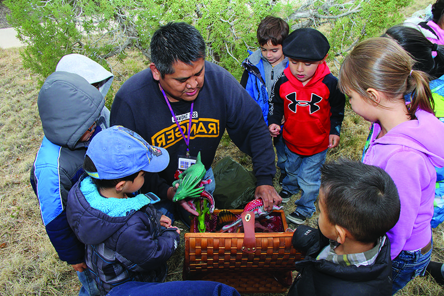 Young students with instructor outdoors exploring